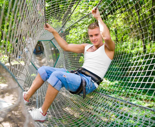 Strong young men in a rope park — Stock Photo, Image
