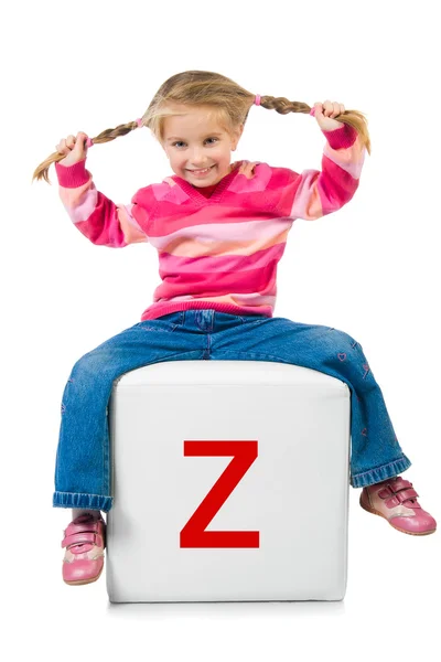 Little kid on the block with letter — Stock Photo, Image