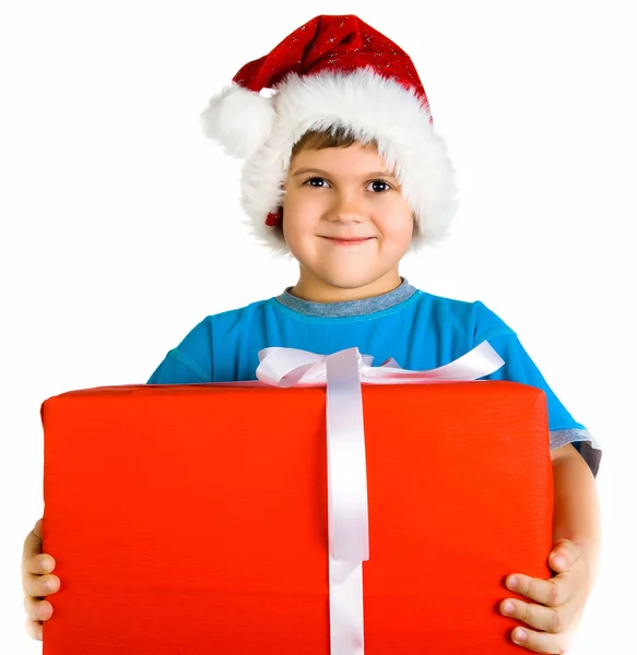 Little boy in santa hat with present — Stok fotoğraf