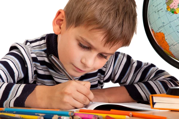 Cute schoolboy is writting — Stock Photo, Image