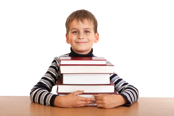 Schoolboy and a heap of books isolated on a white background — Stock Photo, Image