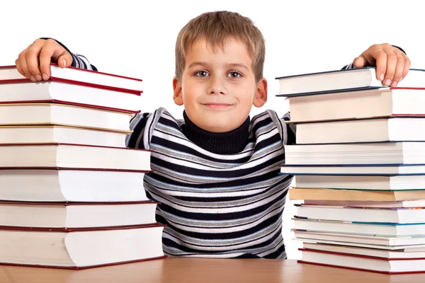 Schoolboy and a heap of books isolated on a white background Stock Photo