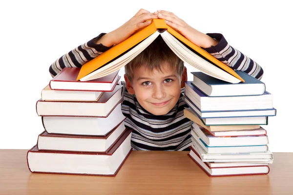 Schoolboy and a heap of books isolated on a white background Royalty Free Stock Images