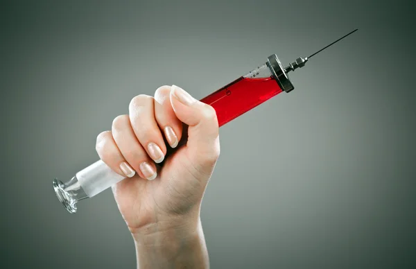 Old medical syringe on a grey background — Stock Photo, Image