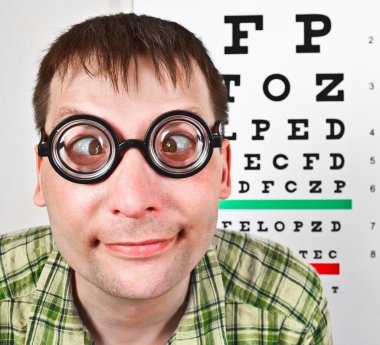 Person wearing spectacles in an office at the doctor clipart