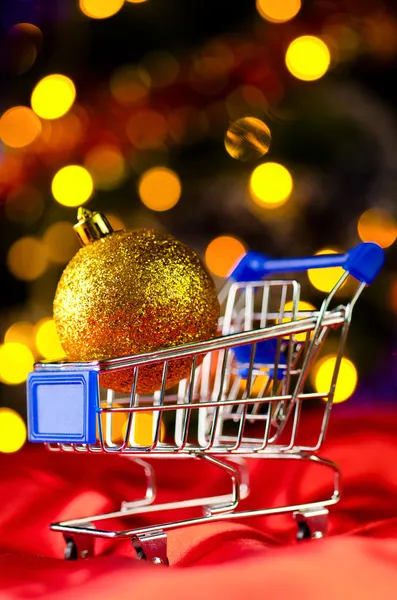 Shopping cart with decorative ball — Stock Photo, Image