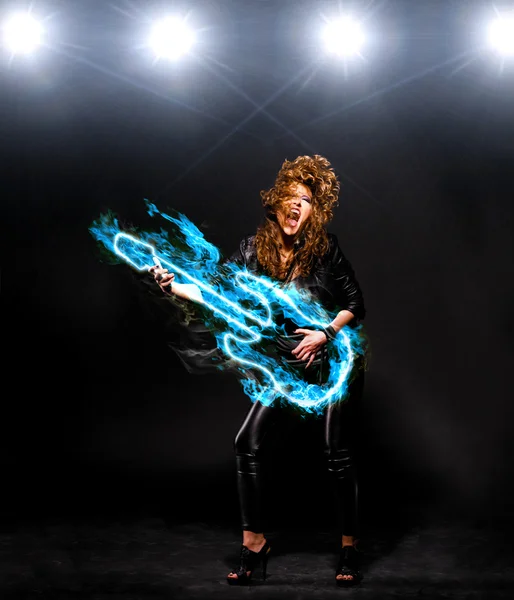 Woman is playing rock music on fiery guitar — Stock Photo, Image