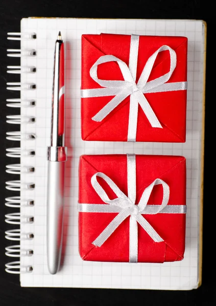 Gift boxes with notepad — Stock Photo, Image