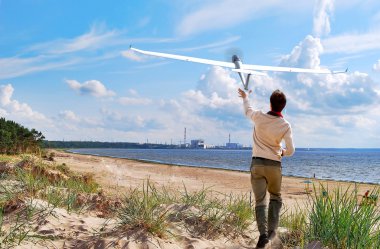 Young boy flying a model of plane clipart