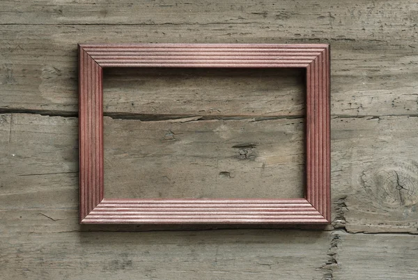 Photo frame on wooden wall — Stock Photo, Image