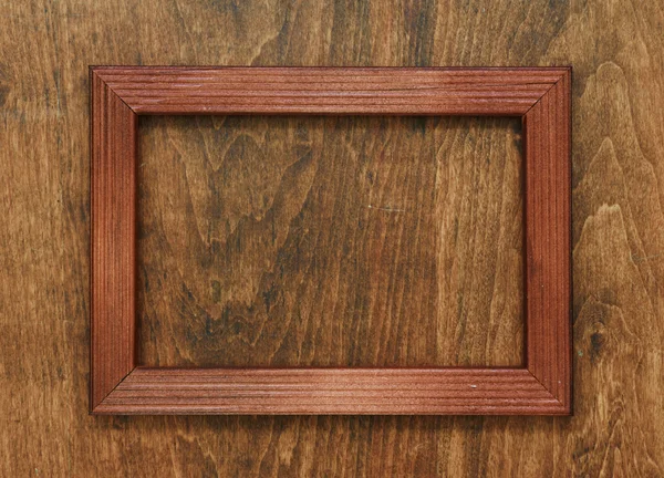 Photo frame on wooden wall — Stock Photo, Image