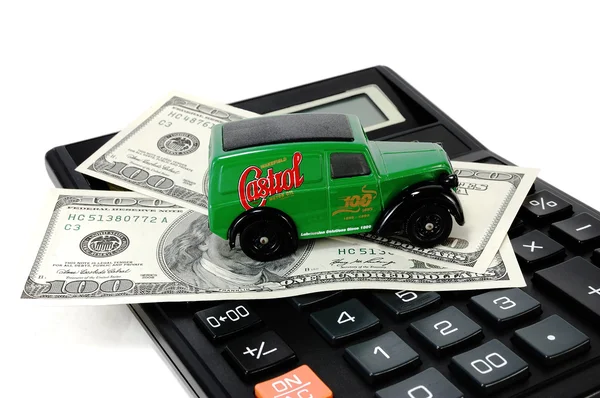 Dollars and the children's machine on the calculator — Stock Photo, Image