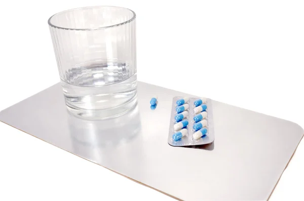 Tablet with a glass of clean water — Stock Photo, Image