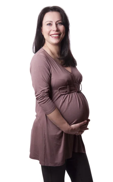 Erwachsene schwangere Frau mit Händen über dem Bauch — Stockfoto