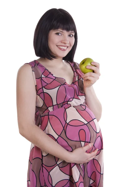 Těhotná žena hospodářství jablko. Stock Snímky