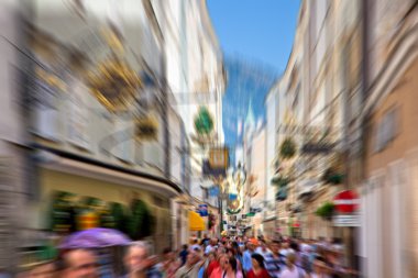 Crowd on a narrow city street clipart