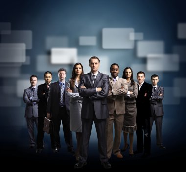 Business team formed of young businessmen standing over a dark background clipart