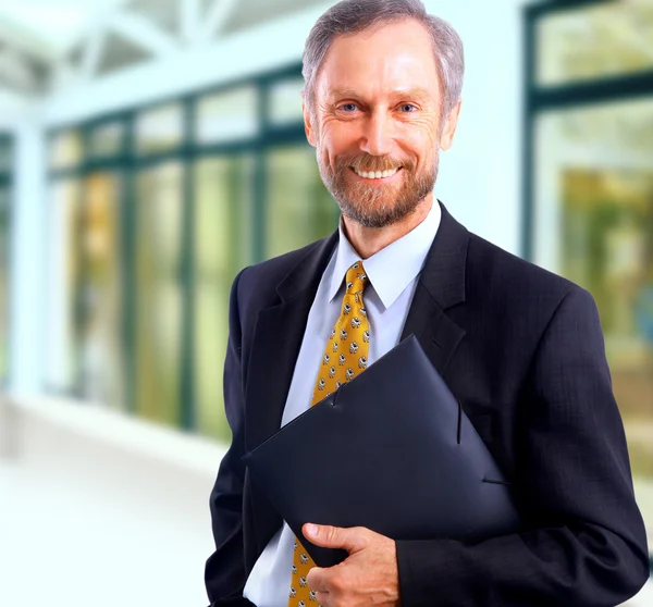 Glimlachende zakenman in zijn kantoor — Stockfoto
