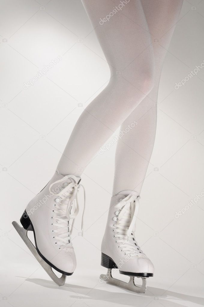 Woman's Legs in White Ice Skates