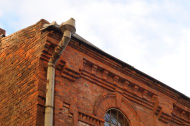 Old Red Brick Building with Downspout