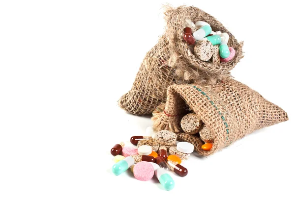 Pills and vitamins in a linen sac Royalty Free Stock Photos
