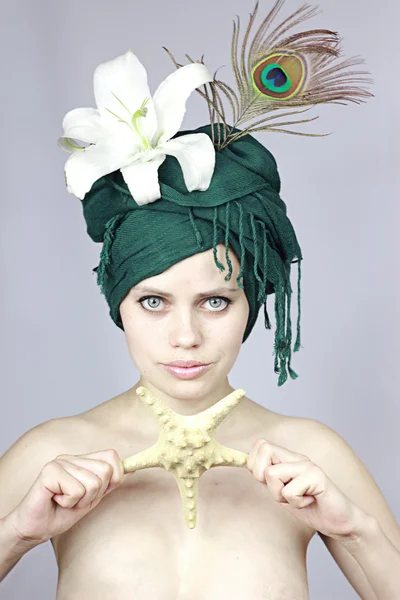 Girl in an exotic cap — Stock Photo, Image