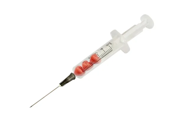 Syringe injecting a red heart — Stock Photo, Image