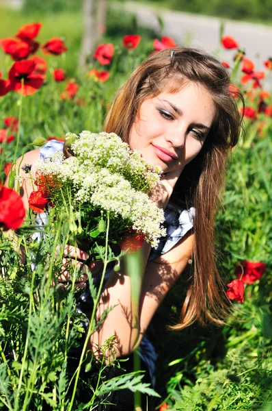 Girl with bunch of wild flowers — Stock Photo, Image
