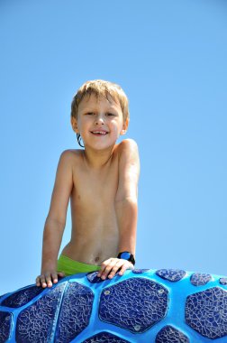 Wet boy coming up of swimming pool clipart