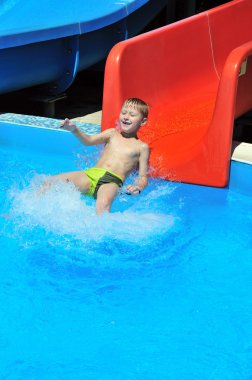 Child on water slide clipart