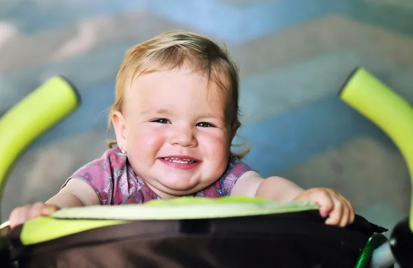 Baby girl having fun in the stroller — Stock Photo, Image