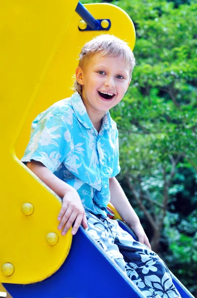 Funny boy on the slide — Stock Photo, Image