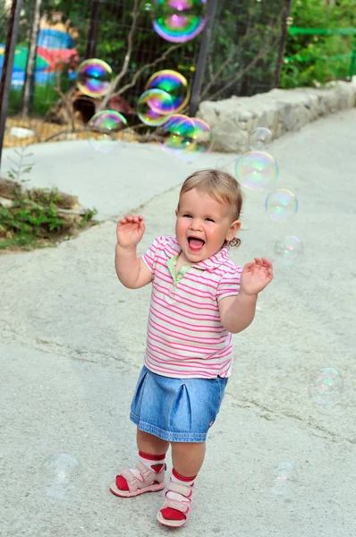 Girl catching soap bubbles — Stock Photo, Image