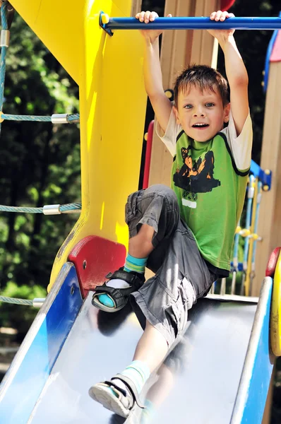 Funny boy on the slide — Stock Photo, Image