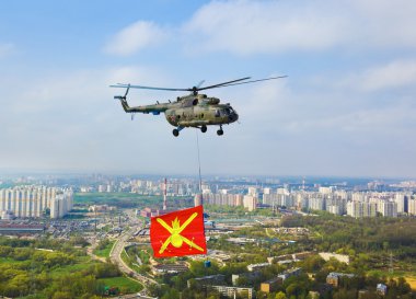 Helicopter with military flag over Moscow at parade of victory d clipart