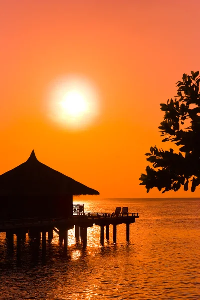 Water bungalows and sunset — Stock Photo, Image