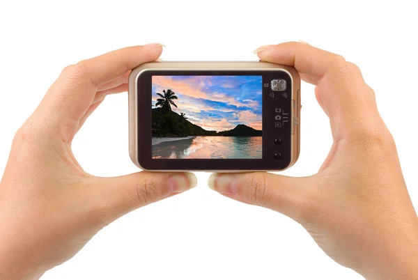 Hand with camera and beach landscape (my photo) — Stock Photo, Image