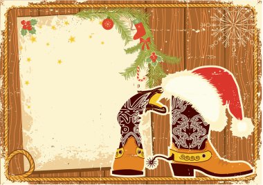 Billboard frame with cowboy boots and Santa's red hat on wood wa clipart