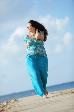 Woman resting at the beach clipart