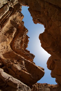 Narrow slot between two rocks in desert canyon clipart