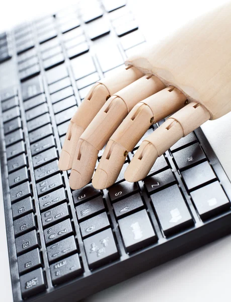 A wooden hand is typing — Stock Photo, Image