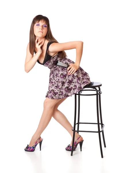Beautiful girl is sitting on a stool — Stock Photo, Image