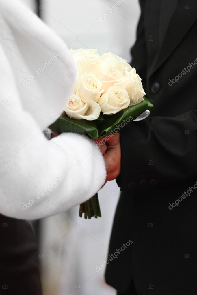 Bride and groom holding wedding flowers