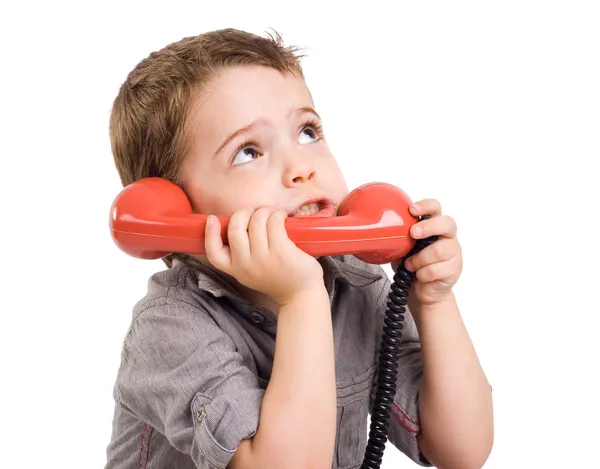Lite gay pojke talar på retro telefon. — Stockfoto