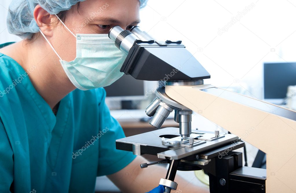 Researcher with microscope
