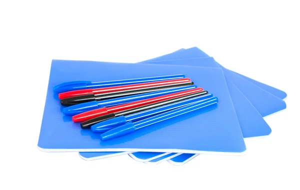 Exercise book with pens — Stock Photo, Image
