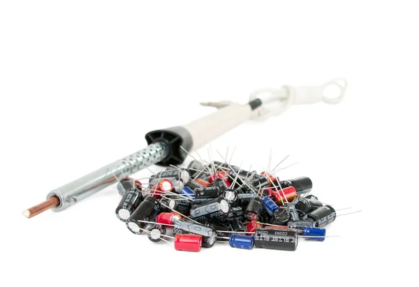 Soldering iron and capacitors — Stock Photo, Image