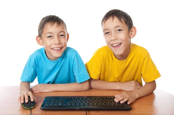 Twins with computer mouse and keyboard — Stock Photo, Image