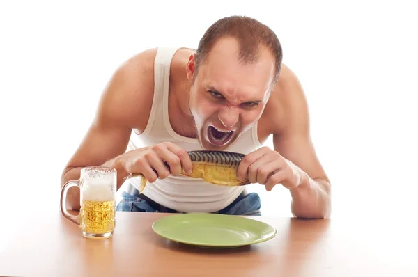 stock image Man drinking beer and eatin fish