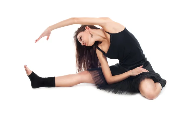 stock image Ballet dancer in black dress doing exercises